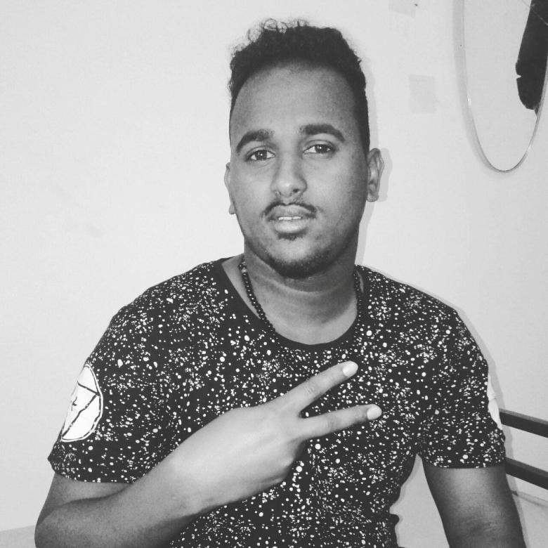 A black and white picture of Rooble gesturing a peace sign with his hand